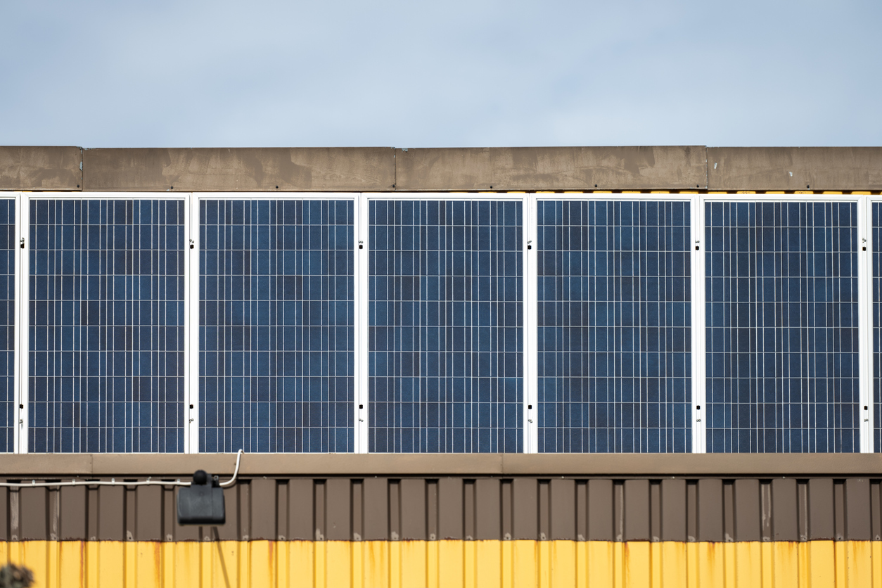 Yellow warehouse with solar panels installation