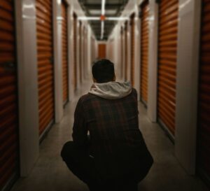 Man in hall of self-storage facility