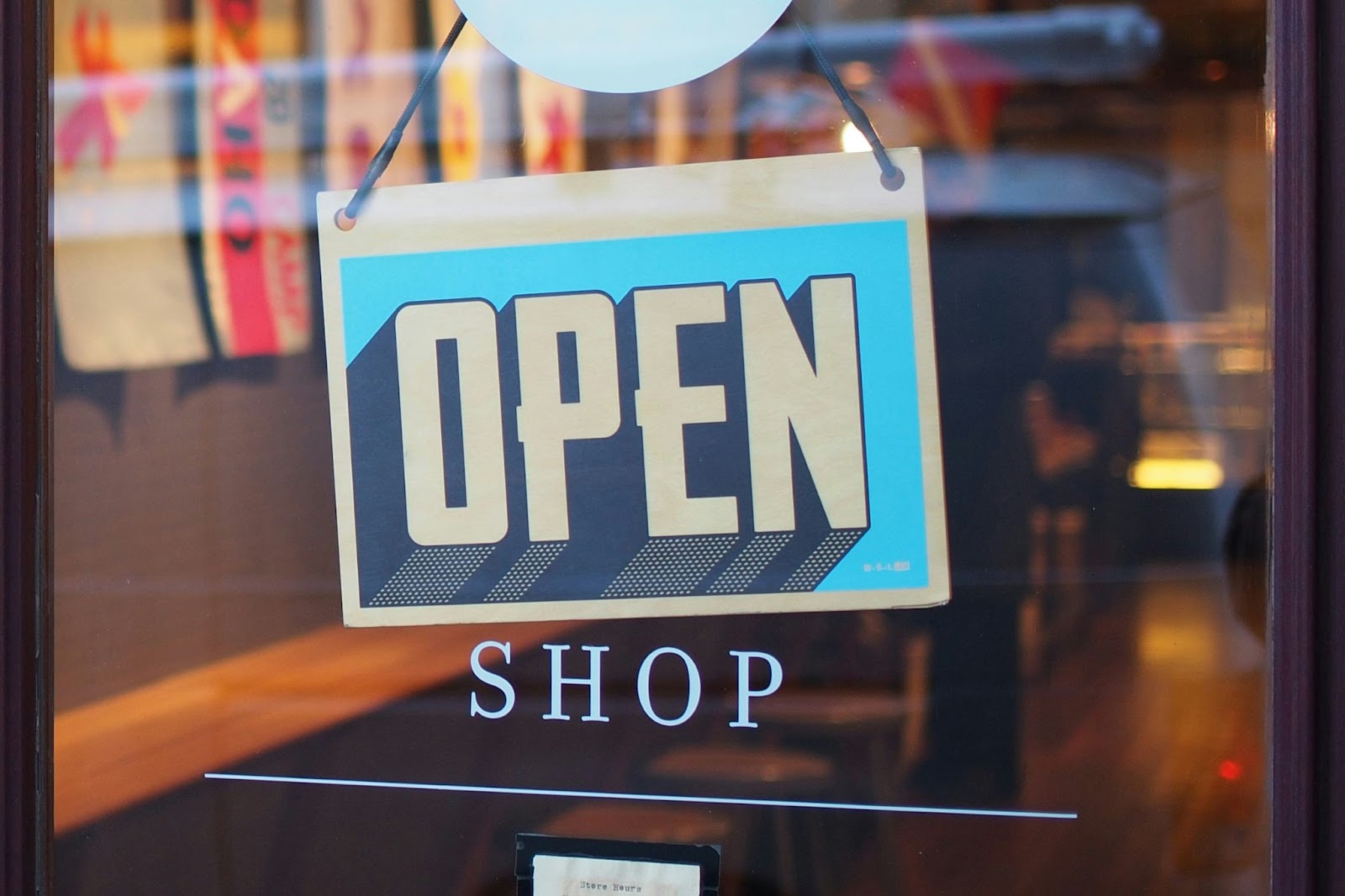 A store with a sign that says “open.”