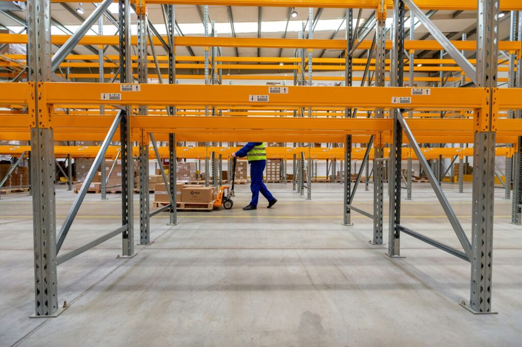 Worker waking in a warehouse.