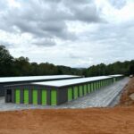 Fortner self storage buildings - grey with light green doors