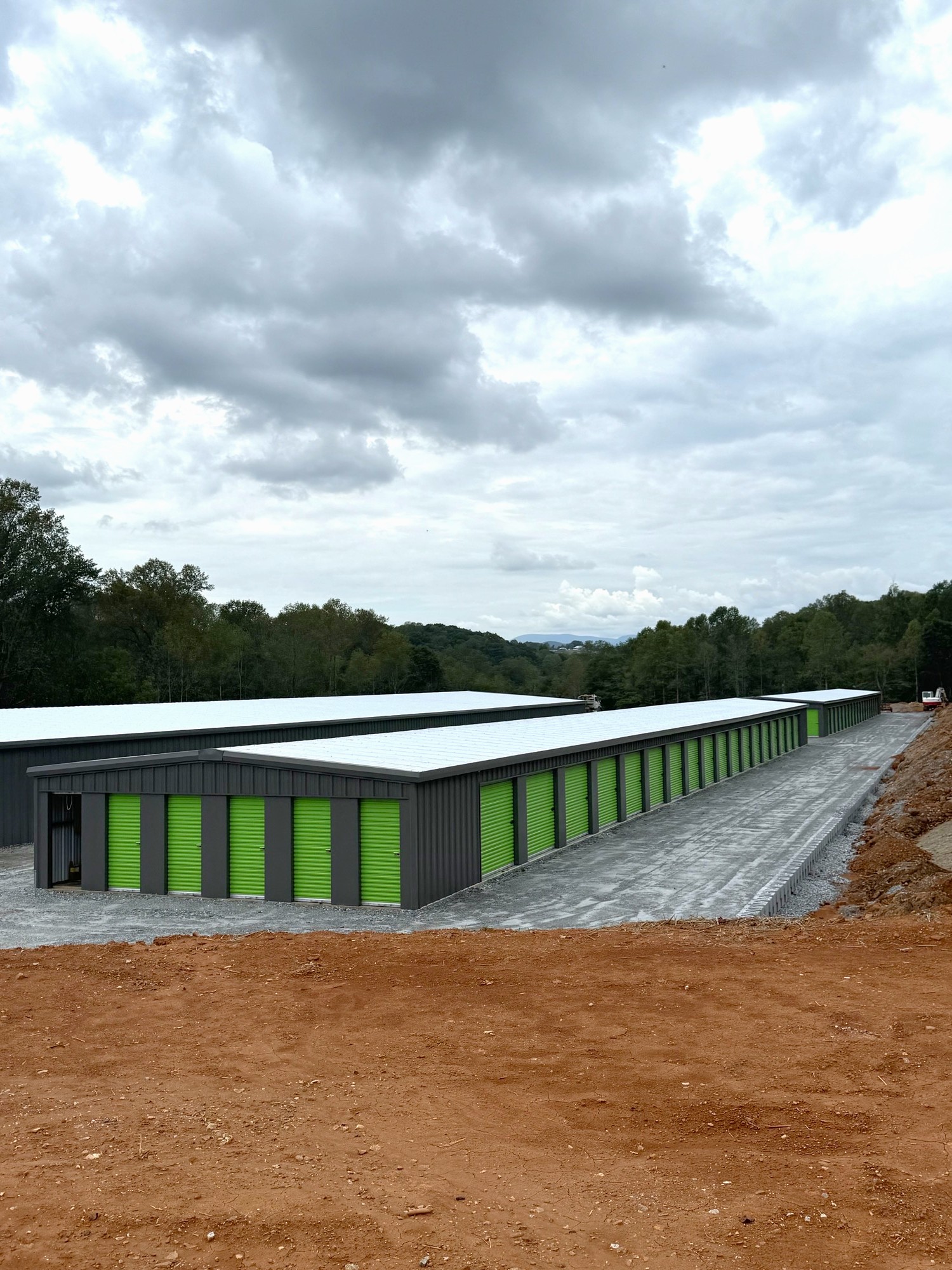 Fortner self storage buildings - grey with light green doors