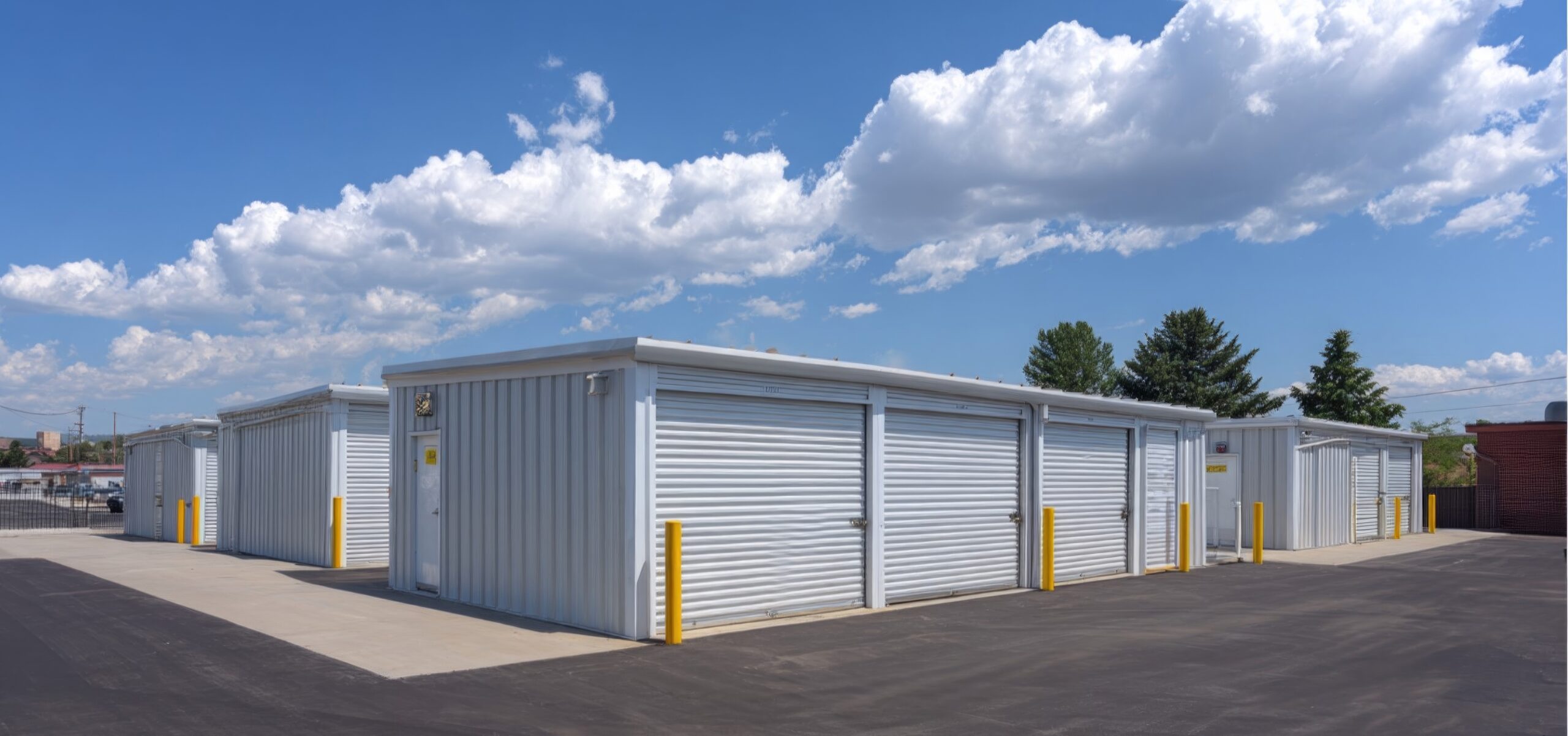 Self Storage Units Under Blue Sky: Rows of modern, clean self-storage units stand under a bright blue sky