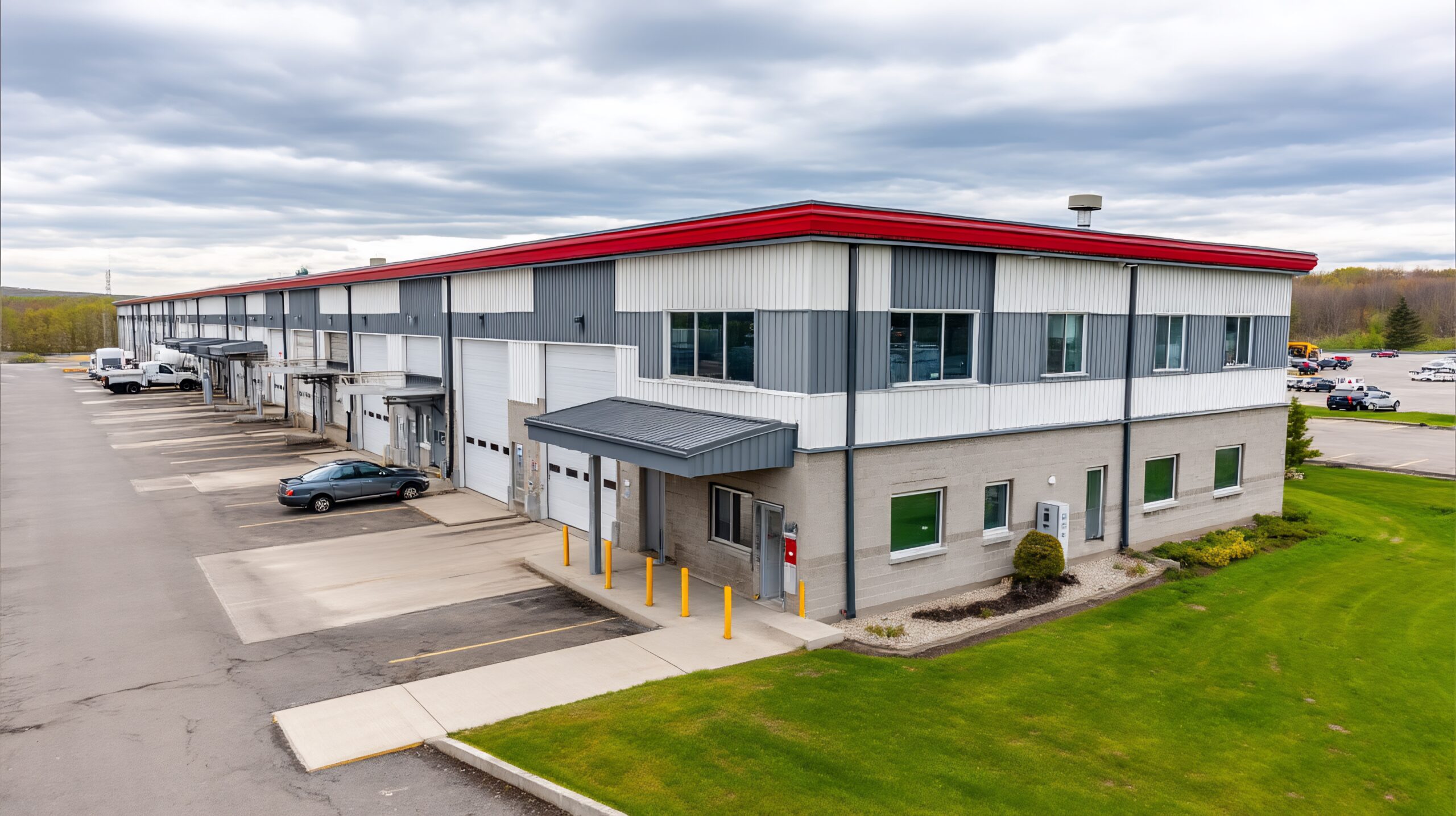 Modern industrial building complex with multiple bays and parking