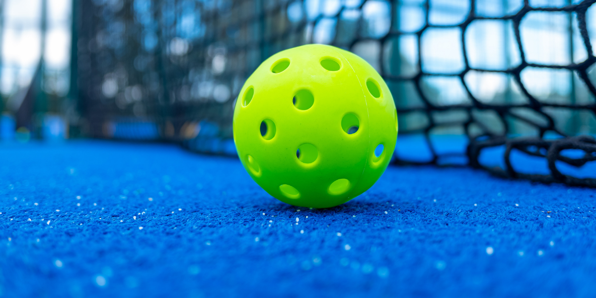 Close-up of a pickleball on an indoor court
