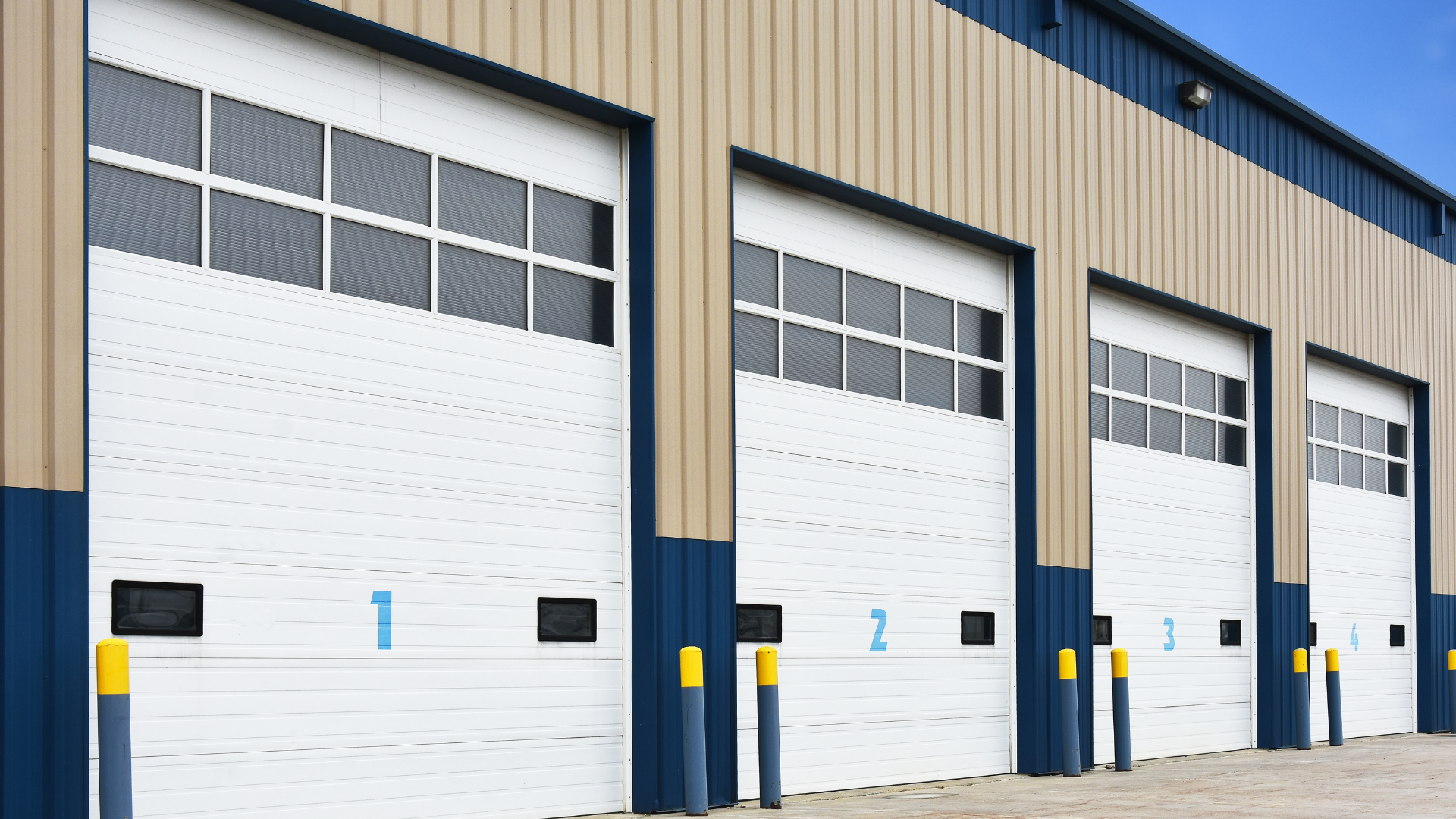 Exterior view of a small bay industrial flex space building with multiple overhead garage doors, designed for warehouse, contractor, and commercial tenant use.