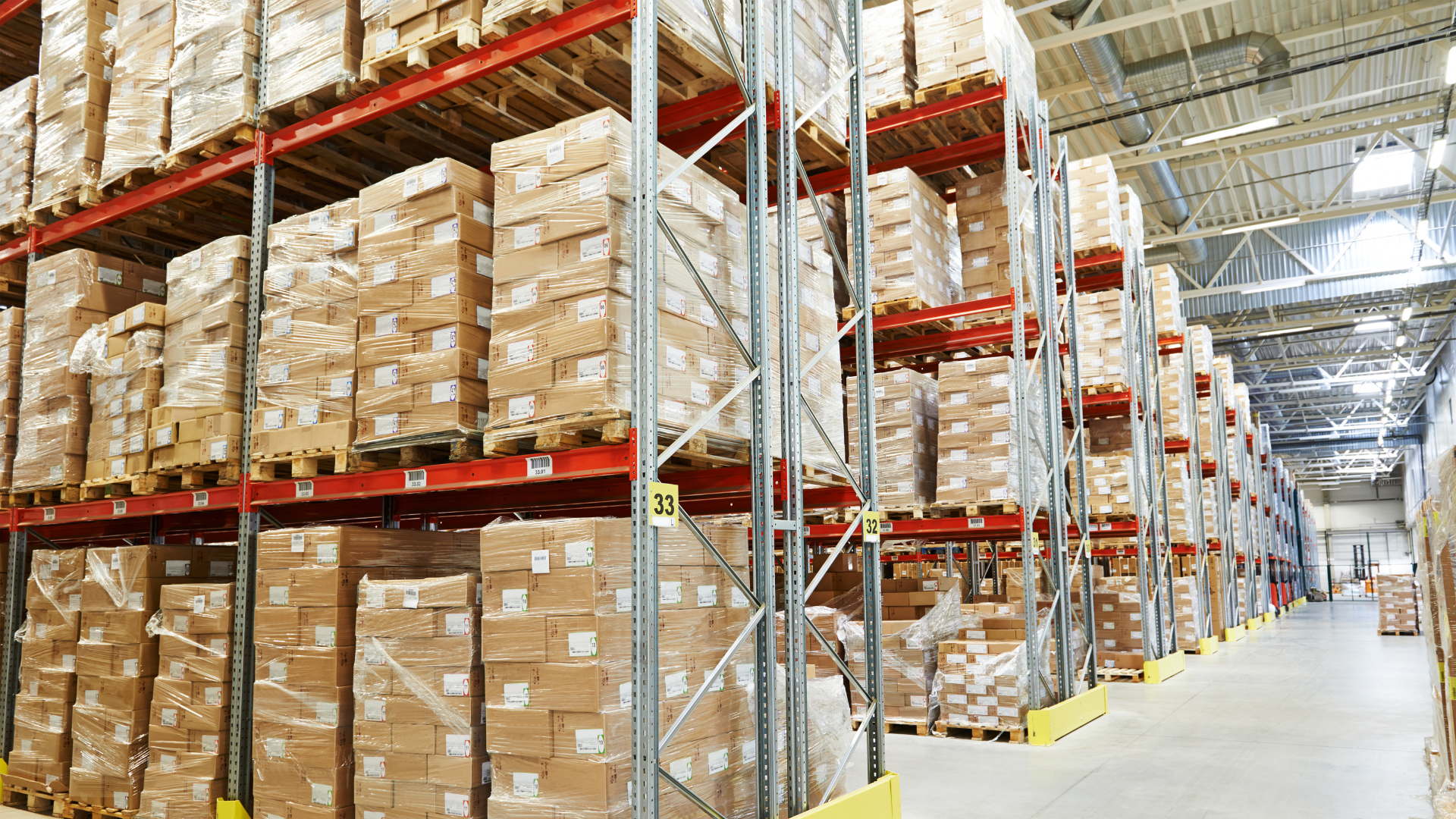 Warehouse interior with pallet racking and inventory storage in a large clear-span steel building.